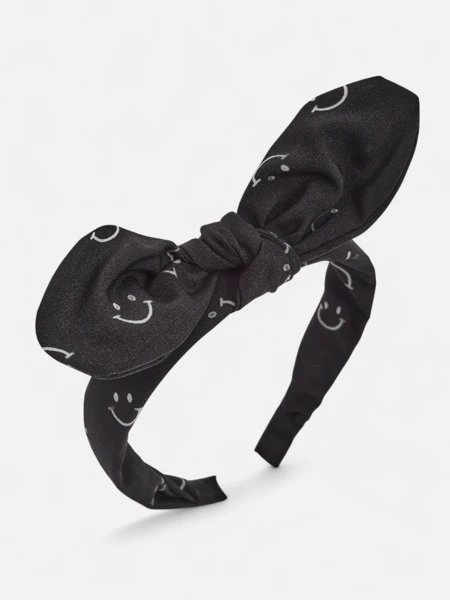Royalfashion Dziecięca opaska do włosów z kokardką z printem w uśmiechnięte buźki