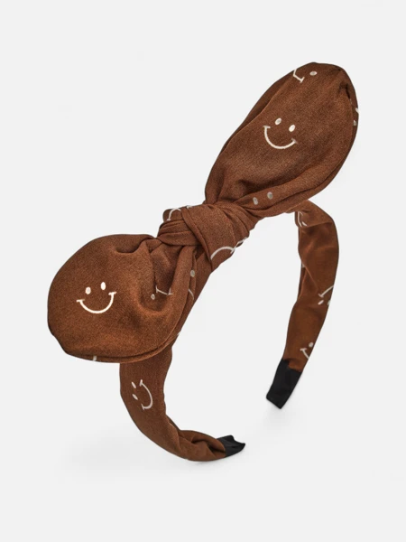 Royalfashion Dziecięca opaska do włosów z kokardką z printem w uśmiechnięte buźki